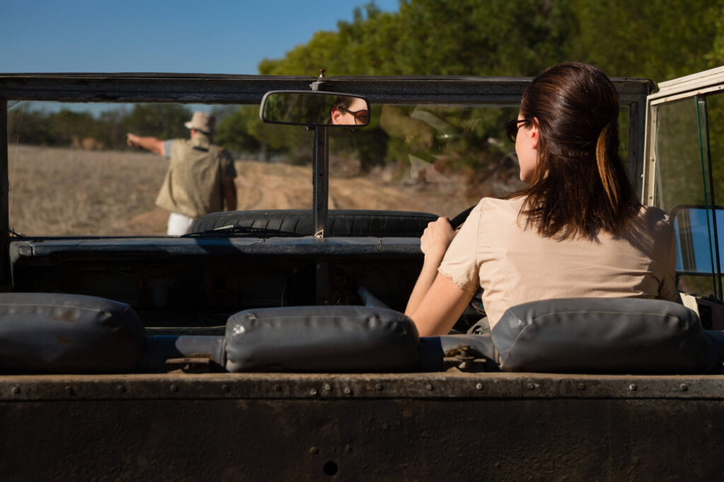 Tourists on a safari vehicle viewing wildlife in the Serengeti