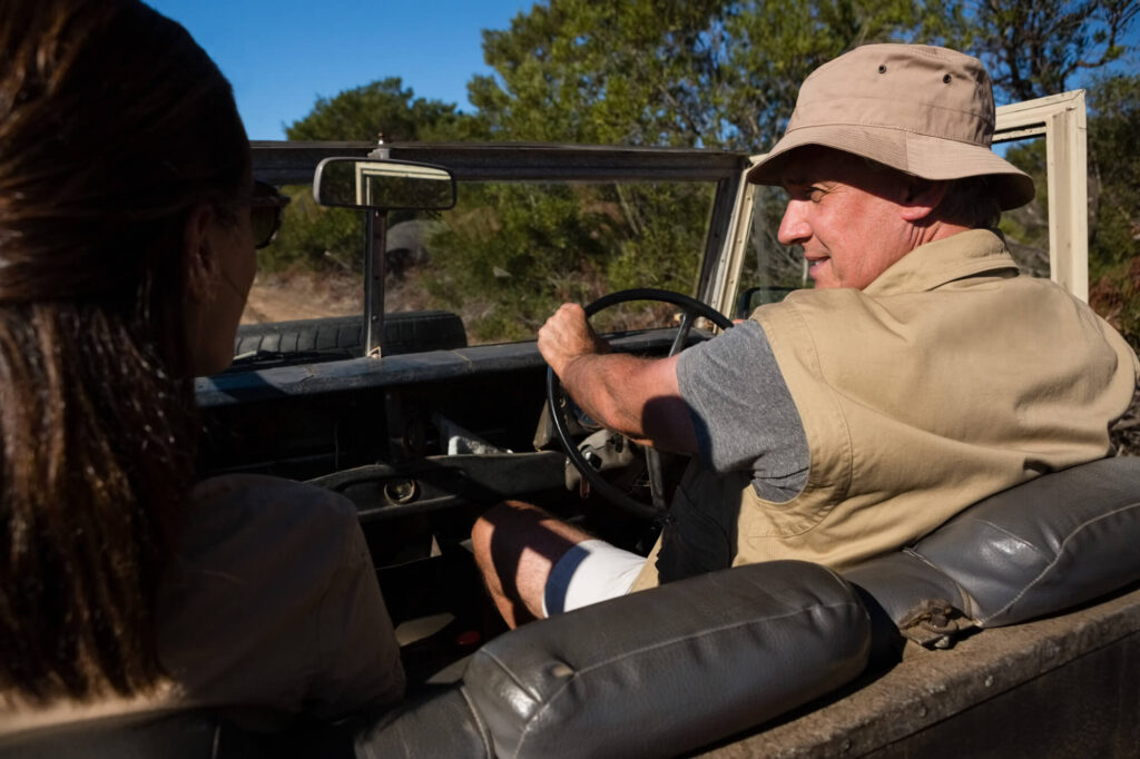 Tanzania safari tour with a guide driving an open safari vehicle