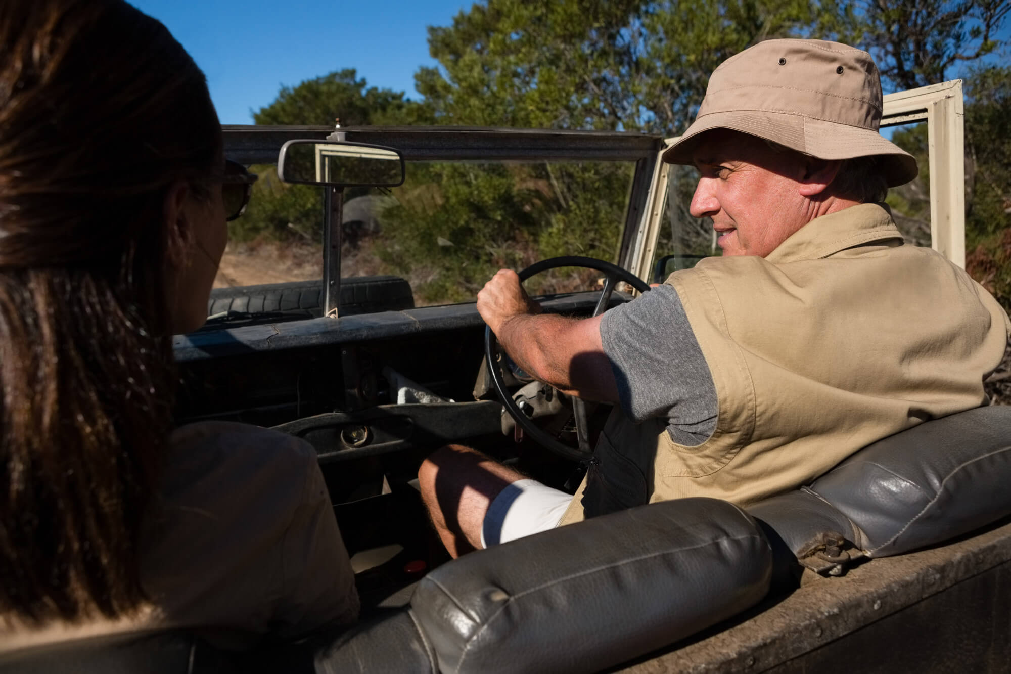 Tanzania safari tour with a guide driving an open safari vehicle